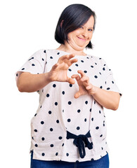 Wall Mural - Brunette woman with down syndrome wearing casual clothes disgusted expression, displeased and fearful doing disgust face because aversion reaction. with hands raised