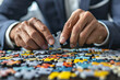 © Jaroon - A man is holding a puzzle piece in his hand