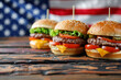 © ink drop - A freshly made beef burger with an american stars and stripes flag. USA holiday food