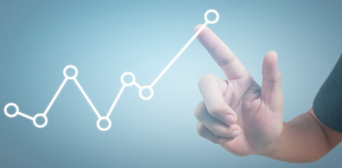 Hand touching graphs of financial indicator and accounting market economy analysis chart