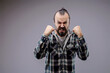 © Giulio_Fornasar - Aggressive man with beard showing fists is feeling angry
