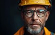 © imagineRbc - A construction worker wearing a yellow hard hat and safety glasses looks directly at the camera
