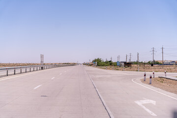 A road with no cars on it. The road is empty and the sky is clear