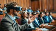 © vadosloginov - A man wearing a VR headset is giving a presentation to a group of people. The audience is attentive and engaged, with some people taking notes. The atmosphere is professional and focused