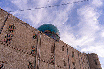 A large building with a blue dome on top. The building is old and has a lot of windows