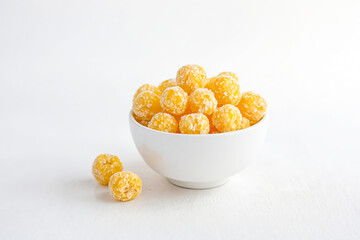 Wall Mural - Coconut-coated yellow balls in a bowl