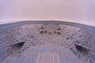 Sticker - A room with a blue and white tile wall. The tiles are arranged in a way that creates a pattern, and the room appears to be a bathroom