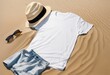 © Mr.Designer - Sand beach texture background. Mockup white summer t-shirt outfit copy space. Blank template woman shirt Top view. Summertime accessories denim, bag. Flat-lay closeup t-shirt on seashore. Beach time