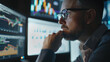 © VK Studio - Close-up on a trader focused on market trends, analyzing multiple graphs and charts on surrounding monitors.