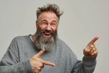 Guy Pointing. Mature Caucasian Man with Beard Smiling and Pointing, Expressing Joy