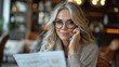 © Photolife   - portrait of a beautiful caucasian mature business woman in glasses talking smiling on the phone while in the office