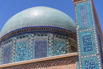 Wall Mural - A blue dome with intricate designs sits atop a building. The building is decorated with blue tiles and has a tall, narrow tower. Scene is one of grandeur and elegance