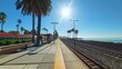© Justlight - Clear sunny skies make waiting for the train a pleasant experience in this seaside setting.