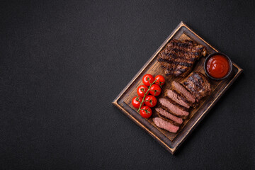 Wall Mural - Fresh juicy delicious beef steak on a dark background