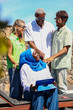 © ADDICTIVE STOCK - Multiethnic business team discussing outdoors in summer