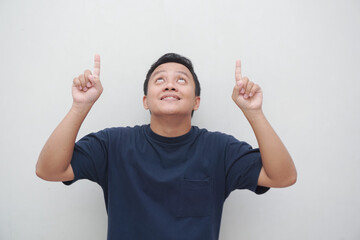 Asian man with shocked expression pointing his finger to copy space. people lifestyle concept. Asian male with t-shirt pointing, isolated on white background.