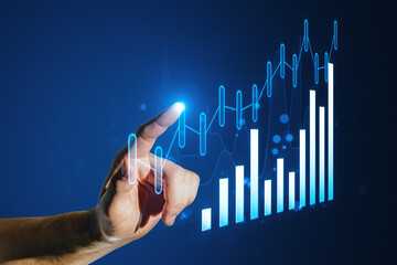 Poster - A hand interacting with glowing digital graphs on a blue background, symbolizing business analytics and futuristic data interaction