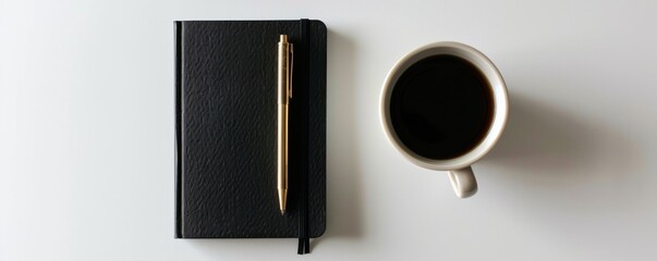 Black notebook with gold pen and cup of coffee on white background, minimalist workspace concept