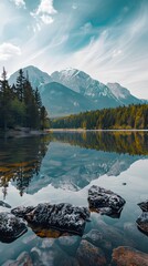 Wall Mural - A serene mountain lake nestled between rugged peaks with a view of the clear sky. reflecting the surrounding snow-capped mountains.