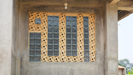Poster - Geometric Glass Block Window on Concrete Wall