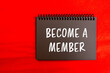© Emre Akkoyun - Become a member message written on black notebook page with red background. Conceptual become a member symbol. Copy space.