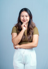 Young beautiful woman smiling joyfully and looking happy, feeling carefree and positive isolated by blue background