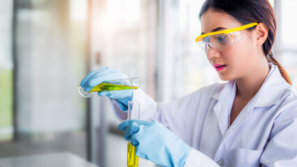 Wall Mural - attractive young asian scientist woman lab technician assistant analyzing sample in test tube at lab