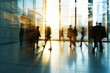 © Igor - Blurred silhouettes of business people walking through a modern office building with large windows. ai generative
