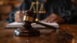 © BoOm - Close-up view of a judge's gavel with scales of justice in the background, signifying law, legal proceedings, and authority.