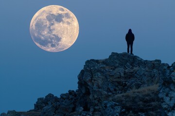 Canvas Print - Person Silhouetted on Rocky Cliff Beneath Full Moon