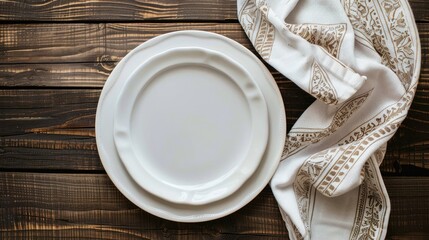 Canvas Print - View from above of an empty white plate on a wooden table with a decorative napkin