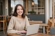 © PNG&Background Image - Happy young girl working with a laptop at a beautiful cozy cafe with copy space.