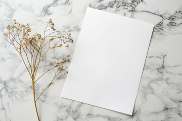 Wall Mural - a white card with a flower on a marble surface