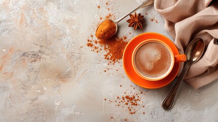 Wall Mural - Orange cup with iron spoon and cocoa on light background Flat lay with space for text