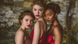 © Andres Mejia - Three models wearing red dresses posing together