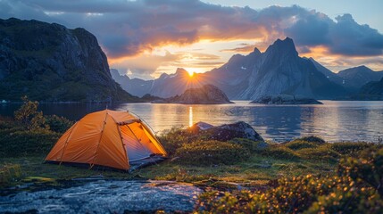 wild camping in the lofoten islands. camping tent among mountains. sunset over camping spot behind polar circle.