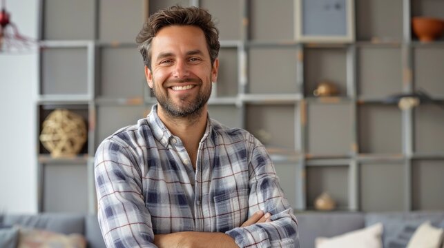 Confident Smiling Man Wearing Plaid Shirt Standing in Modern Office Space
