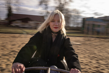 Portrait of a young beautiful blonde girl in a dark coat.