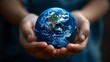 © DudeDesignStudio - Close-up of hands holding a globe, symbolizing care for the planet.