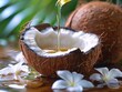© Bantita - Close-up of coconut oil pouring from a cracked coconut, tropical theme with flower and leaf, natural life.
