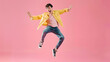 © Generative AI - Happy handsome Asian man in fashionable clothing and jumping doing winner gesture isolated on pink background Portrait of young male cheerful confident and excited jump in air and smil : Generative AI