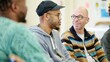 © Ryzhkov - Diverse Group of Men Engaging in Mental Health Discussion at Community Center on International Men's Day