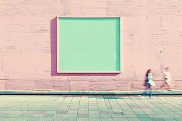 Poster - Dynamic Scene by Pastel Green Wall with Empty Frame and Blurred People Passing in Outdoor Natural Light Setting