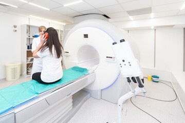 Medical CT or MRI Scan with a patient in the modern hospital laboratory. Interior of radiography department. Technologically advanced equipment in white room. Magnetic resonance diagnostics machine