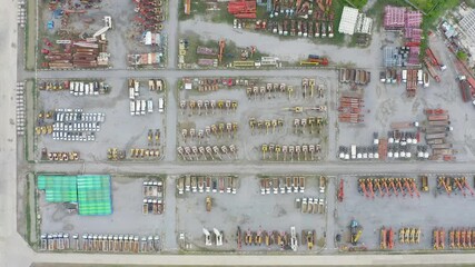 Wall Mural - Aerial view of tractor truck cars in industrial factory for construction site.