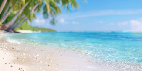 Poster - Blurred background of beautiful white sandy beach with palm trees and blue ocean water. summer vacation concept banner with copy space