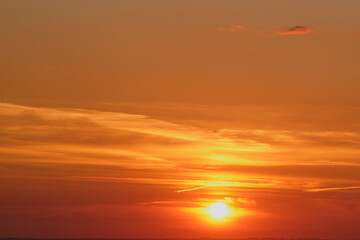 Wall Mural - The evening sky is painted with vibrant red clouds during sunset.