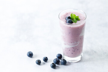 Wall Mural - Blueberry smoothie with yogurt in a glass.