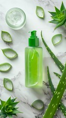 Wall Mural - Aloe vera spa treatment concept. Top view green bottle with aloe vera gel, hand cream and sliced stems aloe vera on marble background. Organic natural skincare products