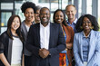 © Mikhail - Confident and diverse business team posing together in a modern office hallway, showcasing unity, collaboration, and professionalism